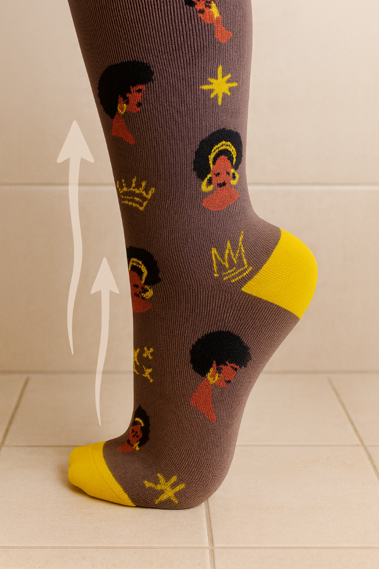 Sock with black women's portraits and yellow accents on a tiled floor